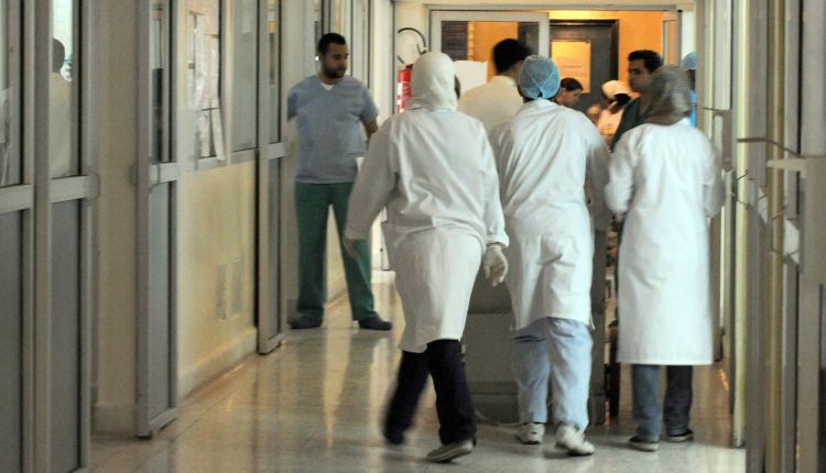 Nurses and doctors walk in a corridor of